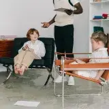 Children engaging in a therapy session with therapist in a modern office.