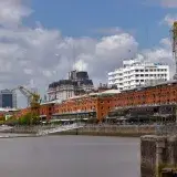 View of the Puerto Madero district with historical cranes and modern buildings in Buenos Aires.