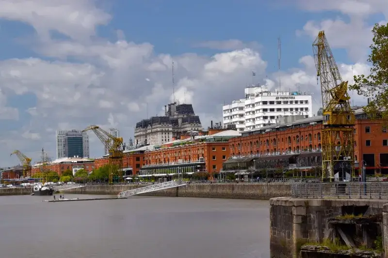 View of the Puerto Madero district with historical cranes and modern buildings in Buenos Aires.