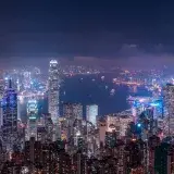 A breathtaking aerial view of Hong Kong's vibrant skyline illuminated at night.