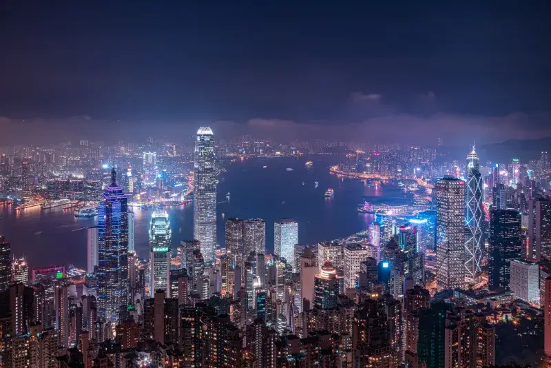 A breathtaking aerial view of Hong Kong's vibrant skyline illuminated at night.