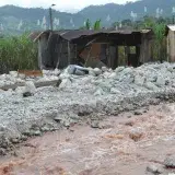 Severe flood damage to rural homes in Mocoa, Colombia, highlighting devastation and recovery needs.