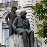 Bronze statue of Saint-Exupéry and Little Prince in Lyon's urban setting.