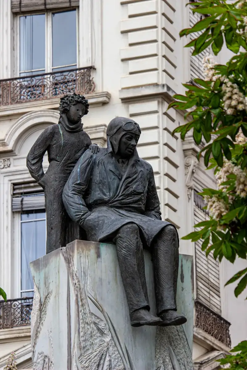 Bronze statue of Saint-Exupéry and Little Prince in Lyon's urban setting.