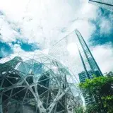 Striking view of Seattle's Amazon Spheres with city skyscrapers under a bright sky.