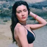 Captivating beach portrait of a woman in Playa Blanca, Spain, exuding summertime warmth and style.