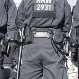 Three police officers and their equipment - on the edge of a demonstration