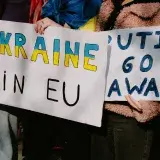 Protest with signs supporting Ukraine in EU and opposing Putin. Capturing a social movement outdoors.
