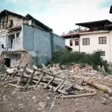 A village destroyed by an earthquake, showcasing damaged buildings and debris.