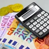 Image of euro banknotes, coins, and a calculator for financial planning. Perfect for finance themes.