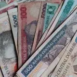 Close-up of assorted vintage Brazilian currency notes displayed in a scattered arrangement.