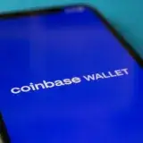 Close-up of a smartphone showing the Coinbase Wallet app interface for cryptocurrency transactions.