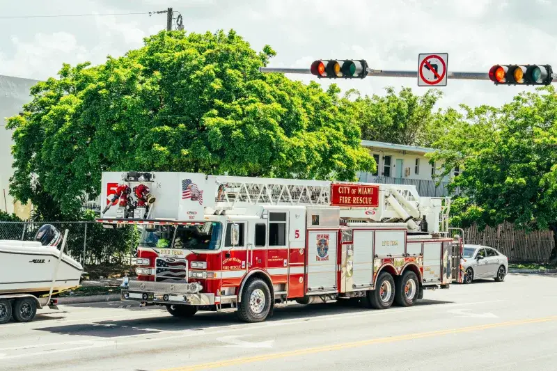 City of Miami fire-rescue truck with dive team module on a sunny street.