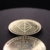 Detailed shot of Bitcoin and Ethereum coins on a dark surface.