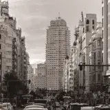 Classic view of Madrid's bustling Gran Vía street showcasing iconic architecture and traffic.