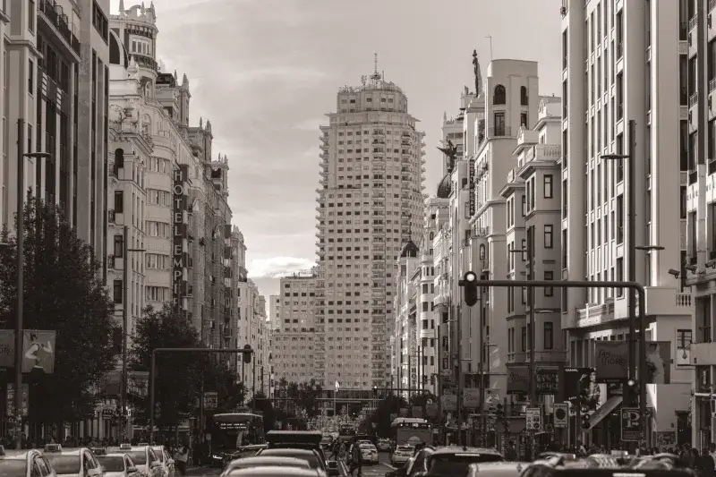 Classic view of Madrid's bustling Gran Vía street showcasing iconic architecture and traffic.