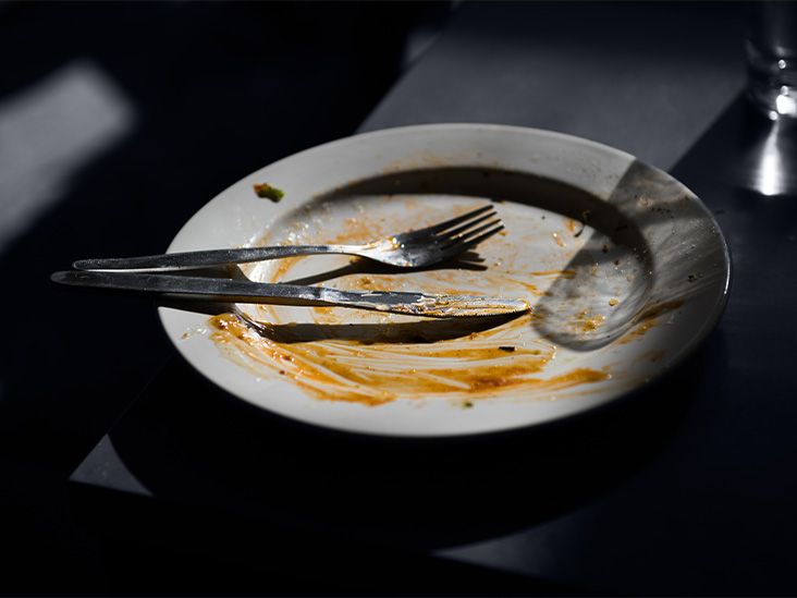 fork and knife resting on dirty empty plate