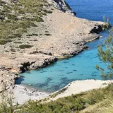 Stunning aerial view of Cala Figuera's turquoise waters and rocky coast in Mallorca, Spain.