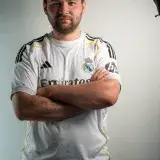 Man posing confidently in a Real Madrid soccer jersey for a portrait shot.