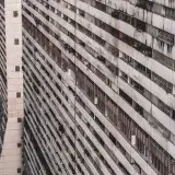 A detailed aerial view of a high-rise apartment building facade in Caracas, Venezuela, showcasing its urban architecture.