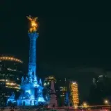 Night view of Angel de la Independencia in Mexico City, featuring vibrant long exposure lights.