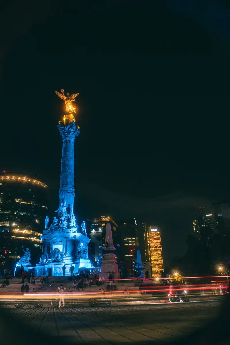 Night view of Angel de la Independencia in Mexico City, featuring vibrant long exposure lights.