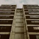 Low angle view of building exterior showcasing windows and sky in Mérida, Venezuela.