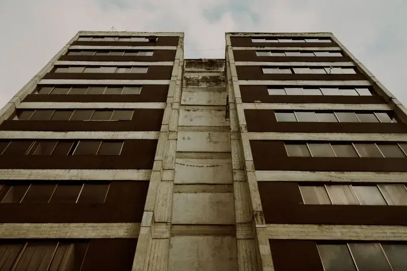 Low angle view of building exterior showcasing windows and sky in Mérida, Venezuela.