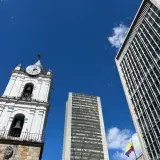 View of modern and historic architecture against a blue sky in Bogotá, Colombia.
