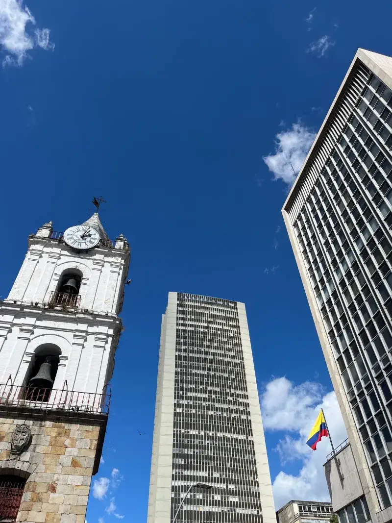 View of modern and historic architecture against a blue sky in Bogotá, Colombia.