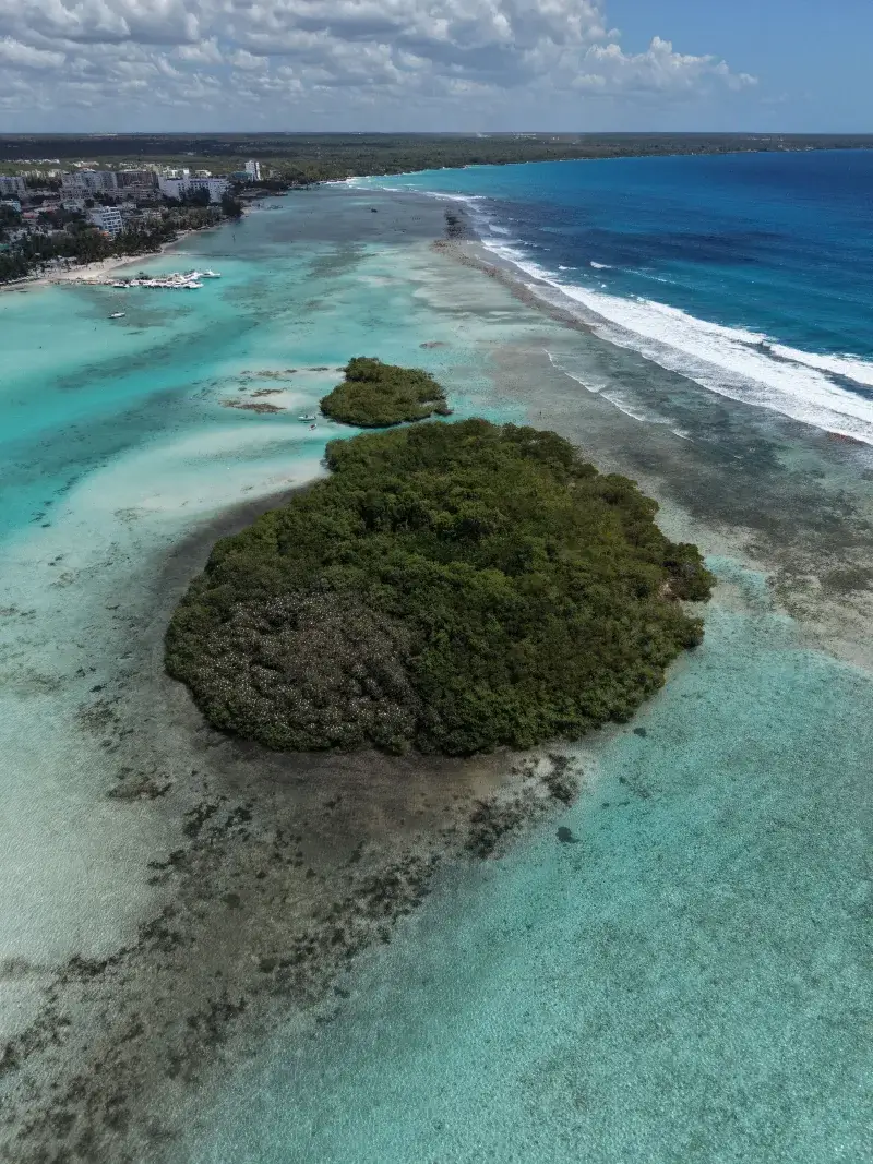 A serene aerial view capturing the coast and turquoise waters near Boca Chica, Dominican Republic.