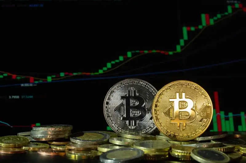 Bitcoin coins in front of a rising financial graph, symbolizing market growth and investment potential.