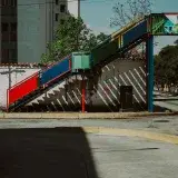 A vibrant pedestrian bridge over quiet urban streets in Mérida, Venezuela.