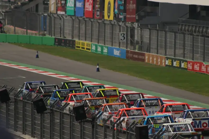 Dynamic truck race at Mexico City's famous Autódromo Hermanos Rodríguez track.