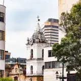 A scenic view of the historic clock tower and modern buildings in Bogotá, Colombia.