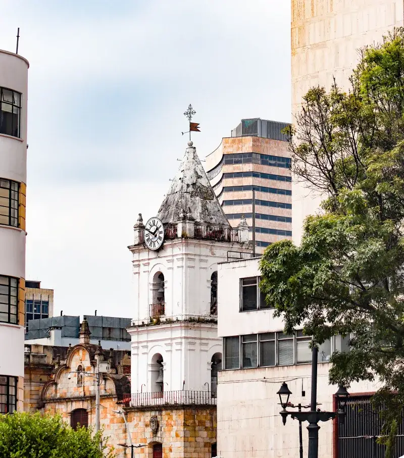 A scenic view of the historic clock tower and modern buildings in Bogotá, Colombia.
