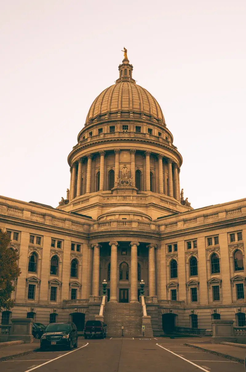 The grand dome and architecture of Wisconsin State Capitol in Madison at dusk.