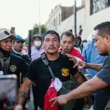 A vibrant protest scene in Lima, Peru, showing diverse participants actively engaged.
