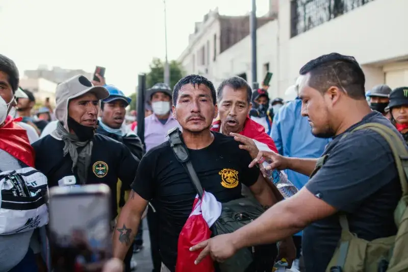 A vibrant protest scene in Lima, Peru, showing diverse participants actively engaged.