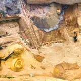 Aerial view of a sand quarry with machinery, showcasing extraction and mining.