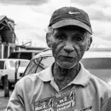 Black and white portrait of an elderly man selling products on the streets of Maracaibo, Venezuela.