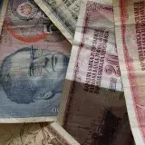 A close-up photo of diverse vintage banknotes, showcasing historical currency from different countries.