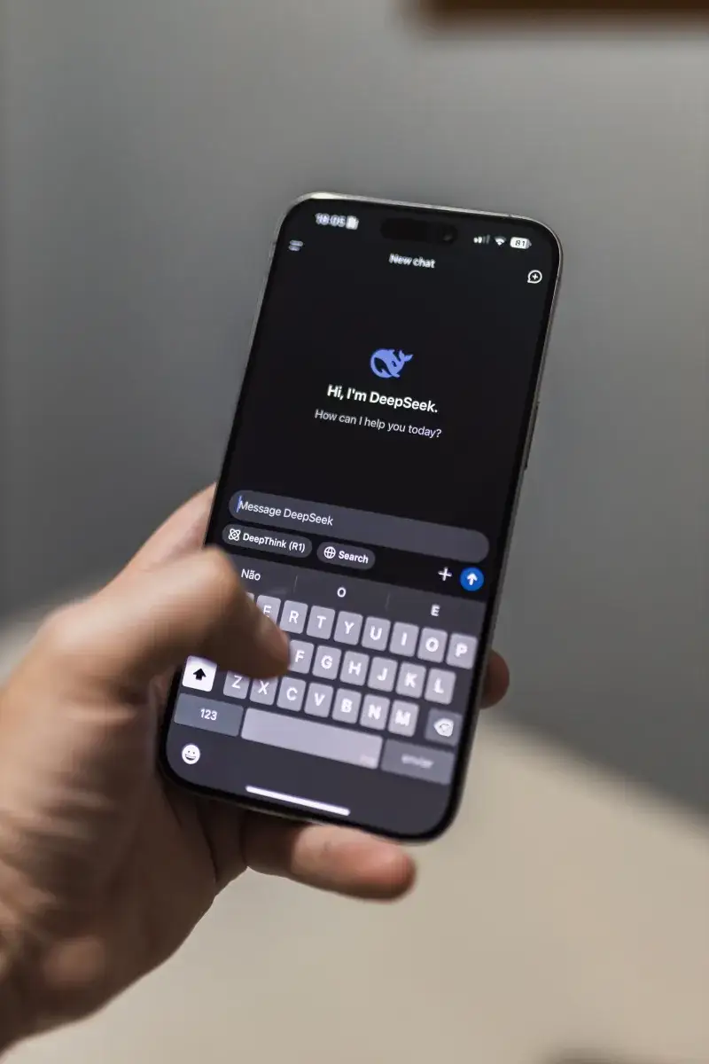 Close-up of a smartphone with an AI chat interface titled "DeepSeek" on the screen.