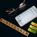 Smartphone displaying cryptocurrency market data alongside blockchain concept elements.