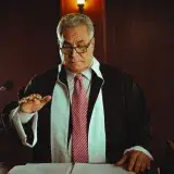 Mature male judge in a courtroom taking an oath, Baghdad, Iraq.