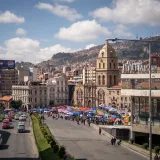Explore the bustling market in La Paz, Bolivia, with its historic architecture and lively atmosphere.
