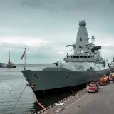 A navy destroyer docked at Odesa harbor with cloudy sky, highlighting maritime defense.