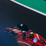 Exciting action shot of a Ferrari F1 car racing at the Interlagos Circuit in Brazil.