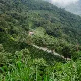 Stunning aerial view of lush green mountains and farm in Jericó, Antioquia, Colombia.
