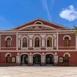 Front view of the historic Teatro Guerra in Lorca, Spain under a clear blue sky.
